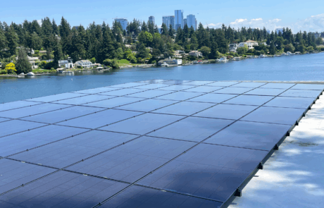 Waterfront solar panel installation in Bellevue, Washington, with city skyline and lakefront homes in the background. Waterfront solar panel installation in Bellevue, Washington, with city skyline and lakefront homes in the background.