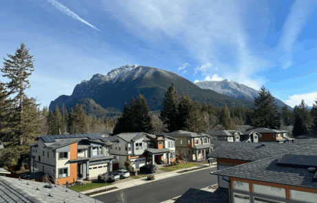 Modern homes with rooftop solar panels in North Bend, Washington, set against a backdrop of snow-capped Cascade Mountains. Modern homes with rooftop solar panels in North Bend, Washington, set against a backdrop of snow-capped Cascade Mountains.