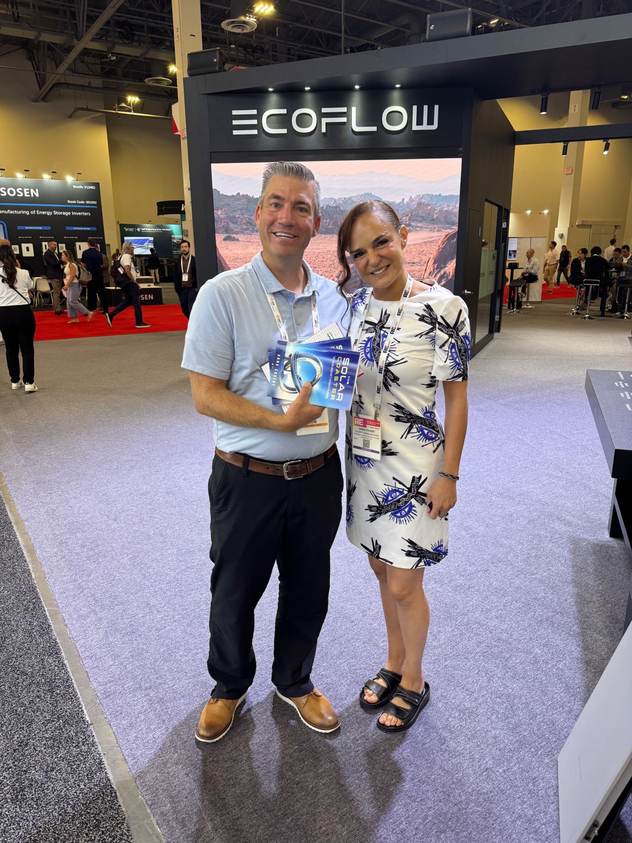 Anna Covert with EcoFlow rep holding The Solar Coaster book at RE+ Las Vegas clean energy event