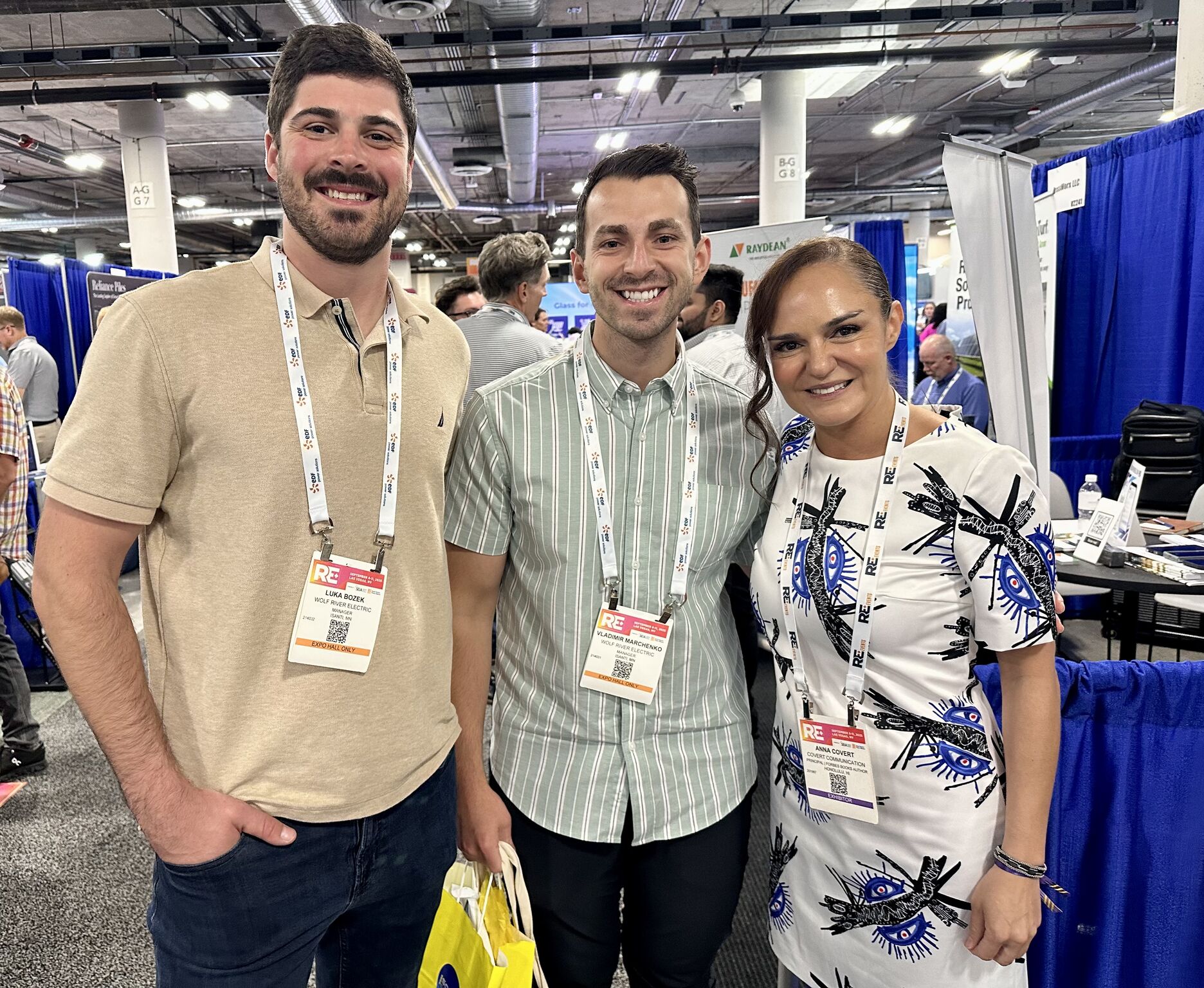 Anna Covert with Vladimir Marchenko and Wolf River Electric colleague at RE+ Las Vegas clean energy event